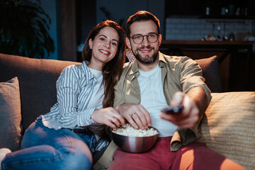 Happy couple enjoying movie night together