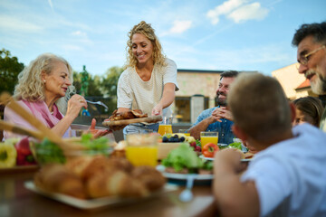 Happy family having lunch together on a sunny day