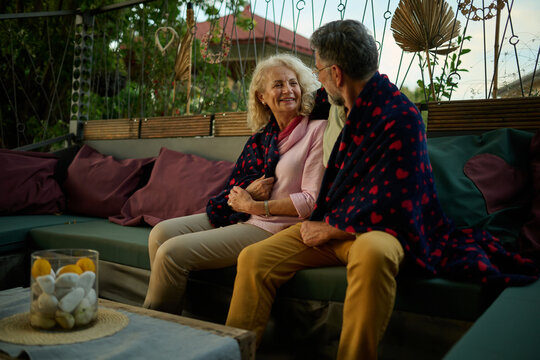 Senior couple relaxing on patio enjoying evening together