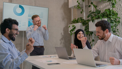 Multi ethnic diverse business team colleagues co-workers corporate partners celebrate victory successful teamwork achievement good result happy businessmen businesswoman in boardroom office win deal
