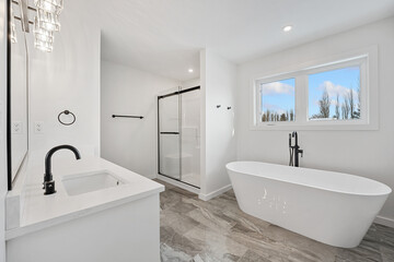 A bathroom with a white tub and sink