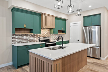 A kitchen with a green island and stainless steel appliances