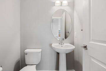 A bathroom with a white toilet and sink
