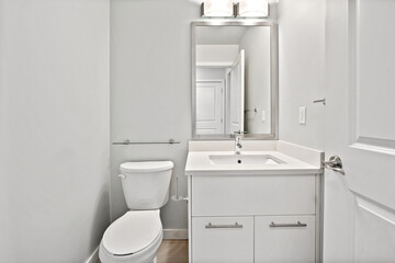 A bathroom with a white toilet and sink
