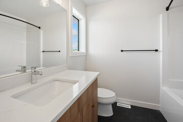 A bathroom with a white sink, toilet, and bathtub