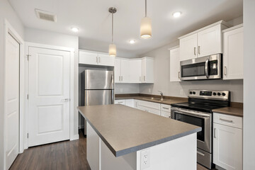 A kitchen with a white refrigerator, microwave, and stove