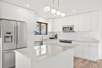 A kitchen with a white island and white cabinets