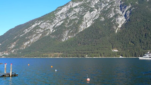 Beautiful landscape of lake Achen on a sunny day with pleasure boat. Austria, Tirol.