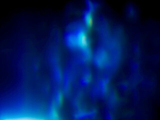 Blue color light leaks on dark background for design and special effects.