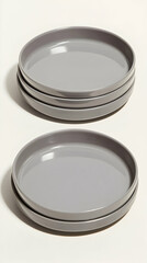 Stacked gray plates, studio shot, minimalist background, tableware