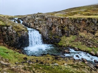 Majestic icelandic waterfall cascading through rocky landscape