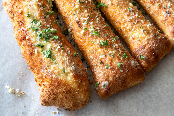 Detail of cheesy bread sticks, Italian cuisine.