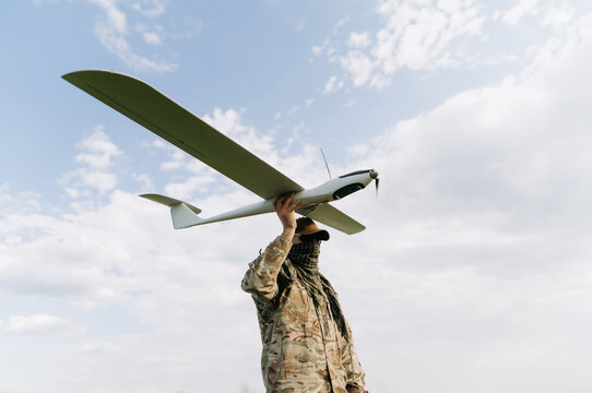 unmanned aerial vehicle in the hands of a soldier. Launching a drone for reconnaissance purposes