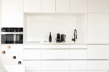 white kitchen. classically executed modern white kitchen with white stone countertop. modern design...