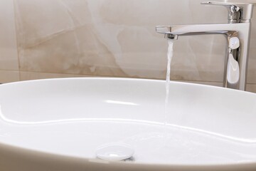 Fototapeta premium hygiene. modern faucet with a convenient sink in the bathroom. daily bathing procedures, washing, brushing teeth go well if there is a convenient sink and a faucet with hot water