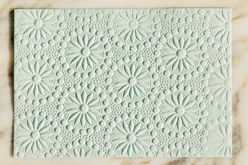 abstract embossed paper floral pattern in light green	