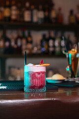 cocktail in a restaurant, professional shooting. a cocktail glass filled with a bright drink, decorated with additional decor. professional photography of a drink