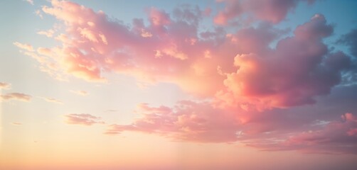 Obraz premium Pastel pink, peach sunset sky. Fluffy clouds with light gradients. Soft colors create beautiful, dreamy atmosphere. Ideal background for various projects. Perfect for nature lovers, interior