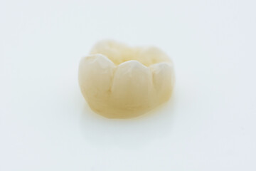 High-quality zirconia dental crown on white background. Dental ceramic crown professional dental lab