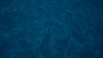 Blue deep water with swirling patterns creating an abstract natural background, aquatic, peaceful, texture