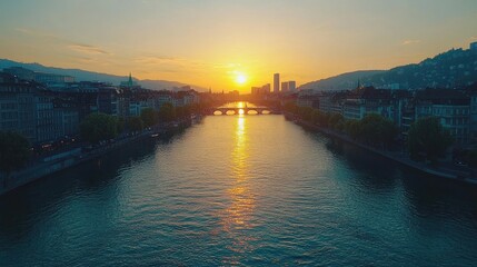 Sunset over a river with cityscape and bridge in the background.