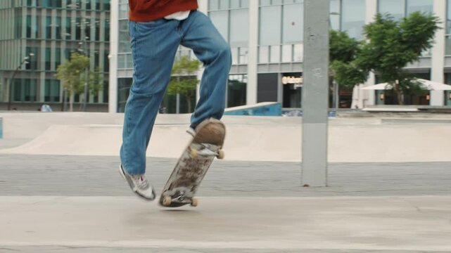 Young skater making 360 flip jump, performing kickflip trick, skateboarder training in skatepark, making tricks, slides and flips, professional extreme sport athlete training ride on skateboard. 