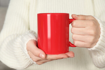 Obraz premium Woman with red ceramic cup, closeup. Mockup for design