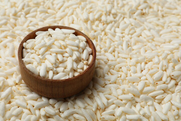 Bowl with puffed rice as background, closeup