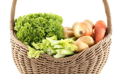 Different fresh vegetables in wicker basket isolated on white