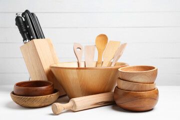 Dishware and cooking utensils on white table