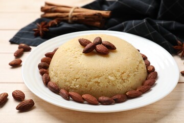Delicious semolina halva with almonds on white wooden table, closeup