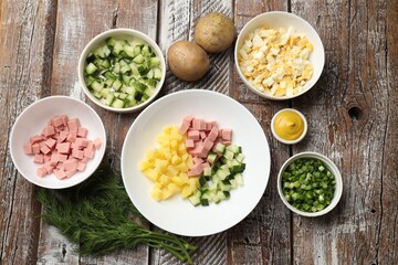 Different ingredients for okroshka soup on wooden table, flat lay