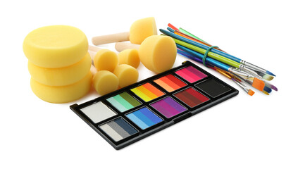 Bright face paint palette, brushes and sponges isolated on white