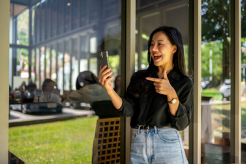 A woman is taking a picture of herself with her cell phone