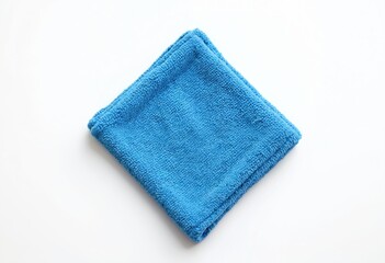 Folded blue microfiber cloth lies flat on white background. Clean, ready for use in kitchen household. High-quality cleaning material for daily tasks. Perfect for wiping surfaces. Versatile, useful