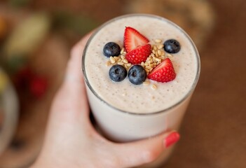 closeup hand holding tasty smoothie