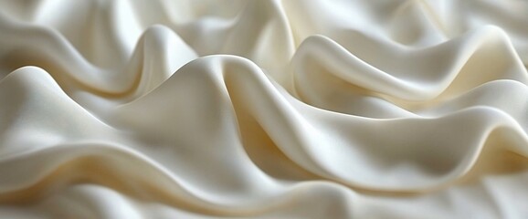 Fototapeta premium Creamy white silk fabric with soft folds and waves.