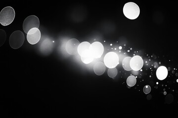 Black and white photo of blurred lights in the dark