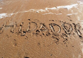 Hi Daddy written in the sand