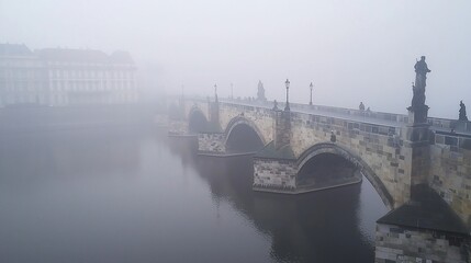 Naklejka premium Foggy ancient stone bridge over calm river.
