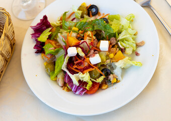 Just cooked mediterranean salad served on table in restaurant.