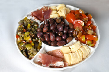 portion of olives with cheese cherry tomatoes and parma ham snack healthy food vegan salad
