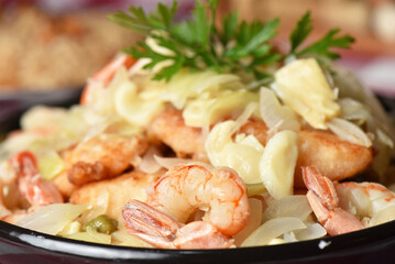 codfish typical Portuguese dish baked cod with onion garlic peppers and potatoes rustic Portuguese food salted fish cooked olive oil