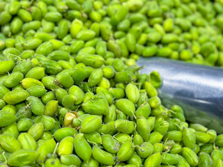A view of a pile of garbanzo seed pods, at the store.