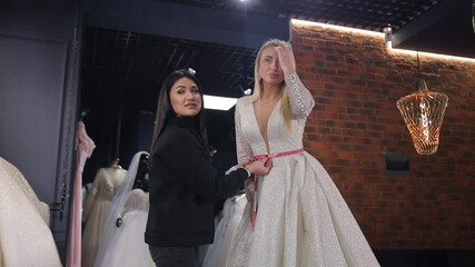 A bridal fitting session conducted with an accomplished designer, highlighting a stunning gown in an elegant boutique