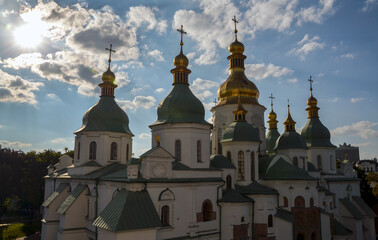 St Sophia Cathedral with golden domes, featuring stunning architecture and illuminated under sunlight, conveying spirituality and cultural heritage in a serene setting. Kyiv, Ukraine