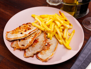 Tasty homemade roasted pork tenderloin served with fried potato