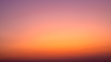 Background image of sky gradient with beautiful pastel pink and orange and purple in the evening as the sun sets, Atmosphere of the twilight sky was calmin in evening, calm sky in winter evening.