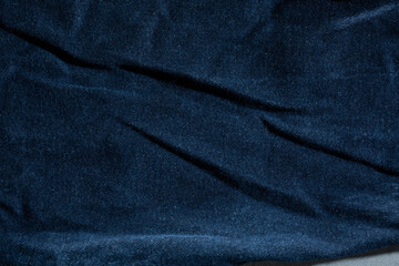 A top down view of blue denim material, as a background.