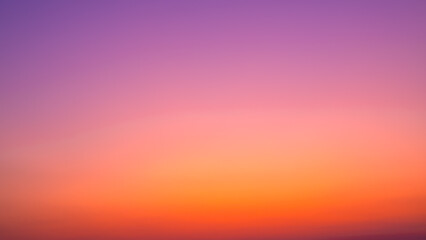 Background image of sky gradient with beautiful pastel pink and orange and purple in the evening as the sun sets, Atmosphere of the twilight sky was calmin in evening, calm sky in winter evening.